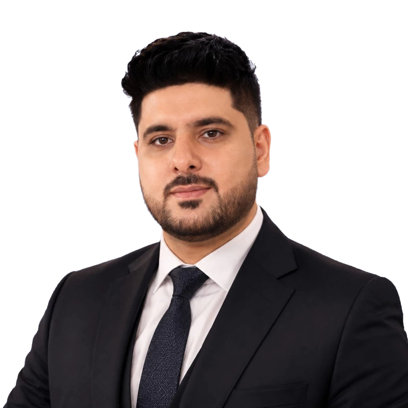Nadeem Asghar wearing a dark suit, white shirt, and dark tie